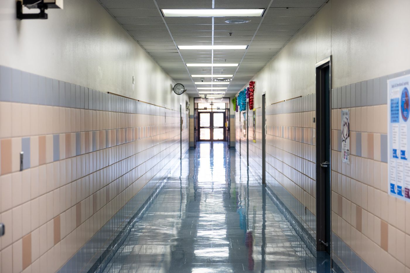Bright school hallway with lockers and overhead lights